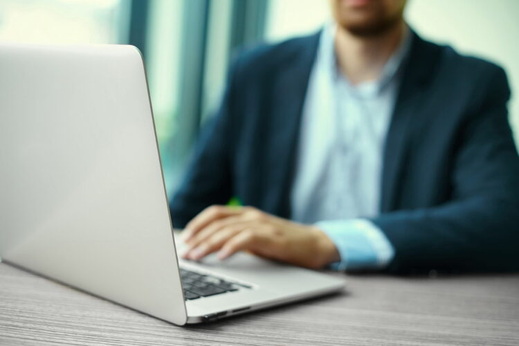 Man working on a laptop. Document Management